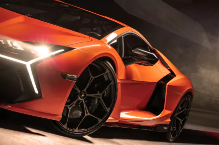 Orange Lamborghini Revuelto vehicle, low-angle close-up in dramatic lighting — high-detail 4K Ultra HD PC desktop wallpaper and background.