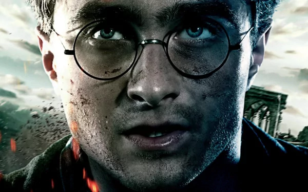 Close-up of Harry Potter with glasses, dirt, and intense expression from the movie Harry Potter and the Deathly Hallows: Part 2, featured as an HD PC desktop wallpaper.