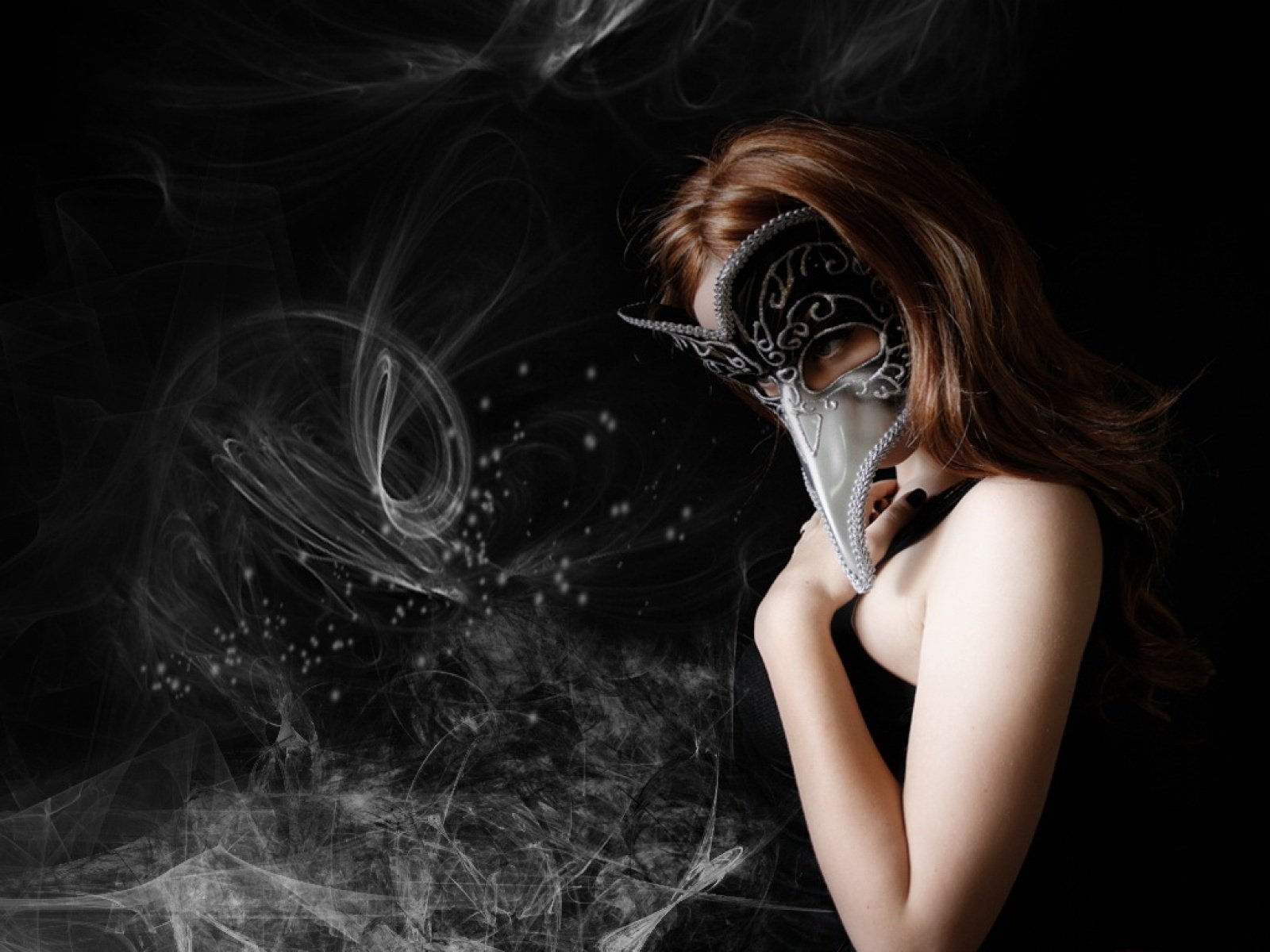 HD desktop wallpaper featuring a mysterious figure wearing an ornate black and white bird-like mask against a dark, smoky background in a striking photographic style.