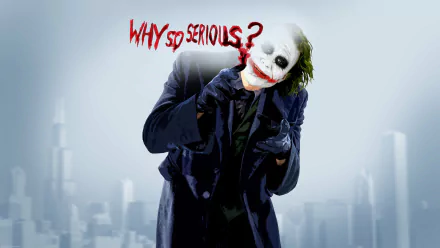 HD PC desktop wallpaper of the Joker in a dark coat, smeared clown makeup and green hair, grinning beneath red Why so serious? scrawl over a misty city skyline.
