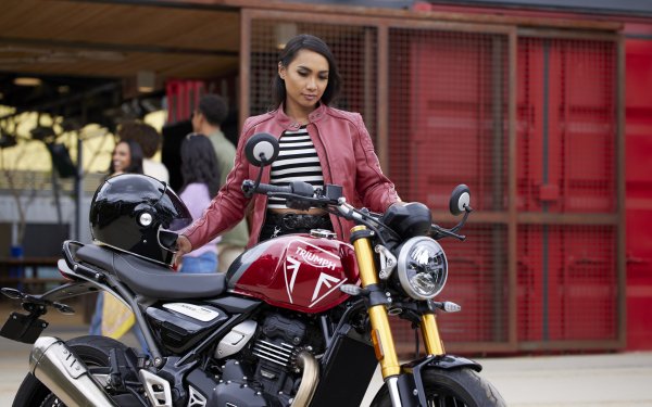 HD desktop wallpaper featuring a person with a Triumph Speed 400 motorcycle, set against an urban backdrop.