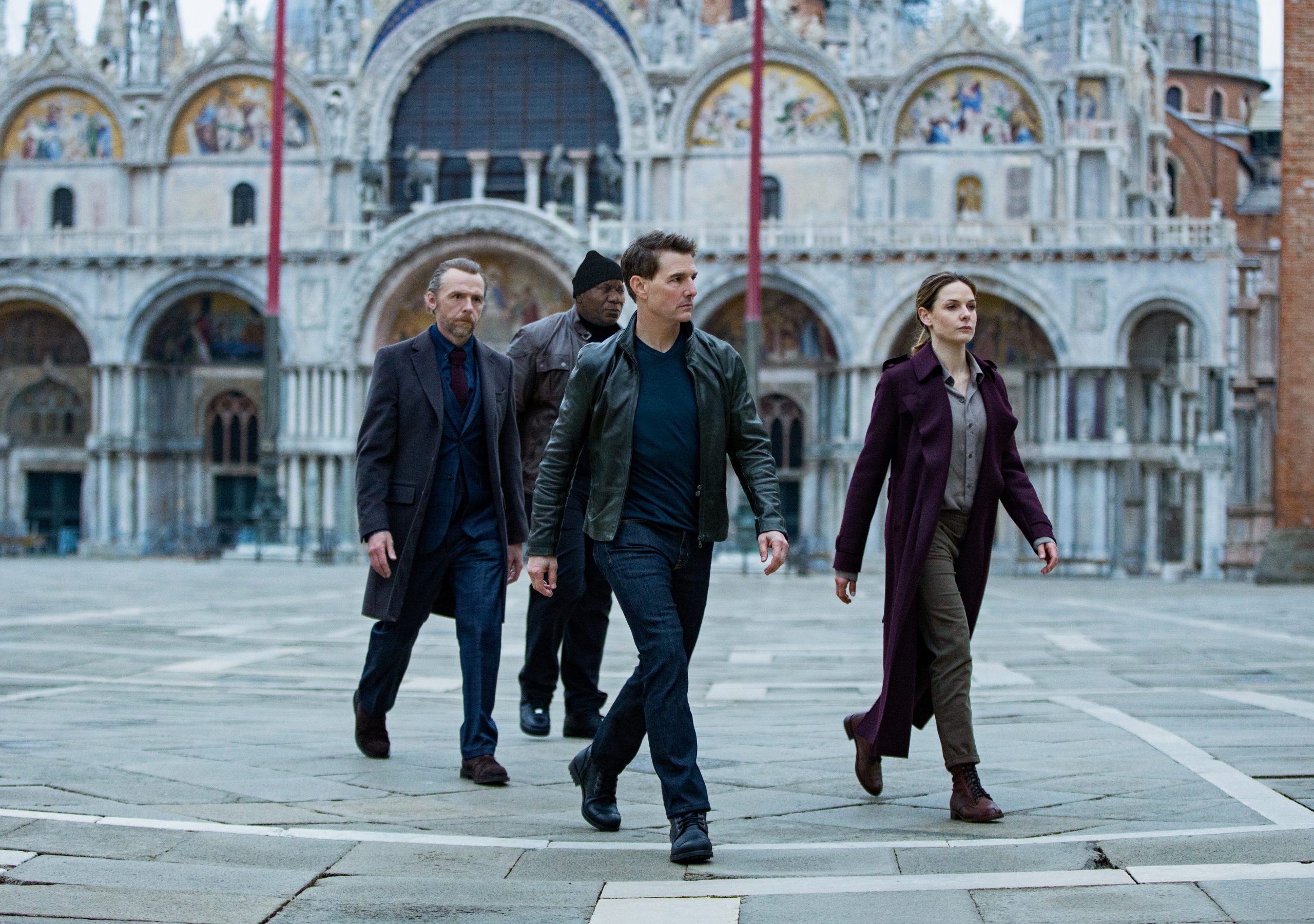 Four characters stride confidently across a grand European square in a still from Mission: Impossible - Dead Reckoning Part One, available as an HD desktop wallpaper and background.