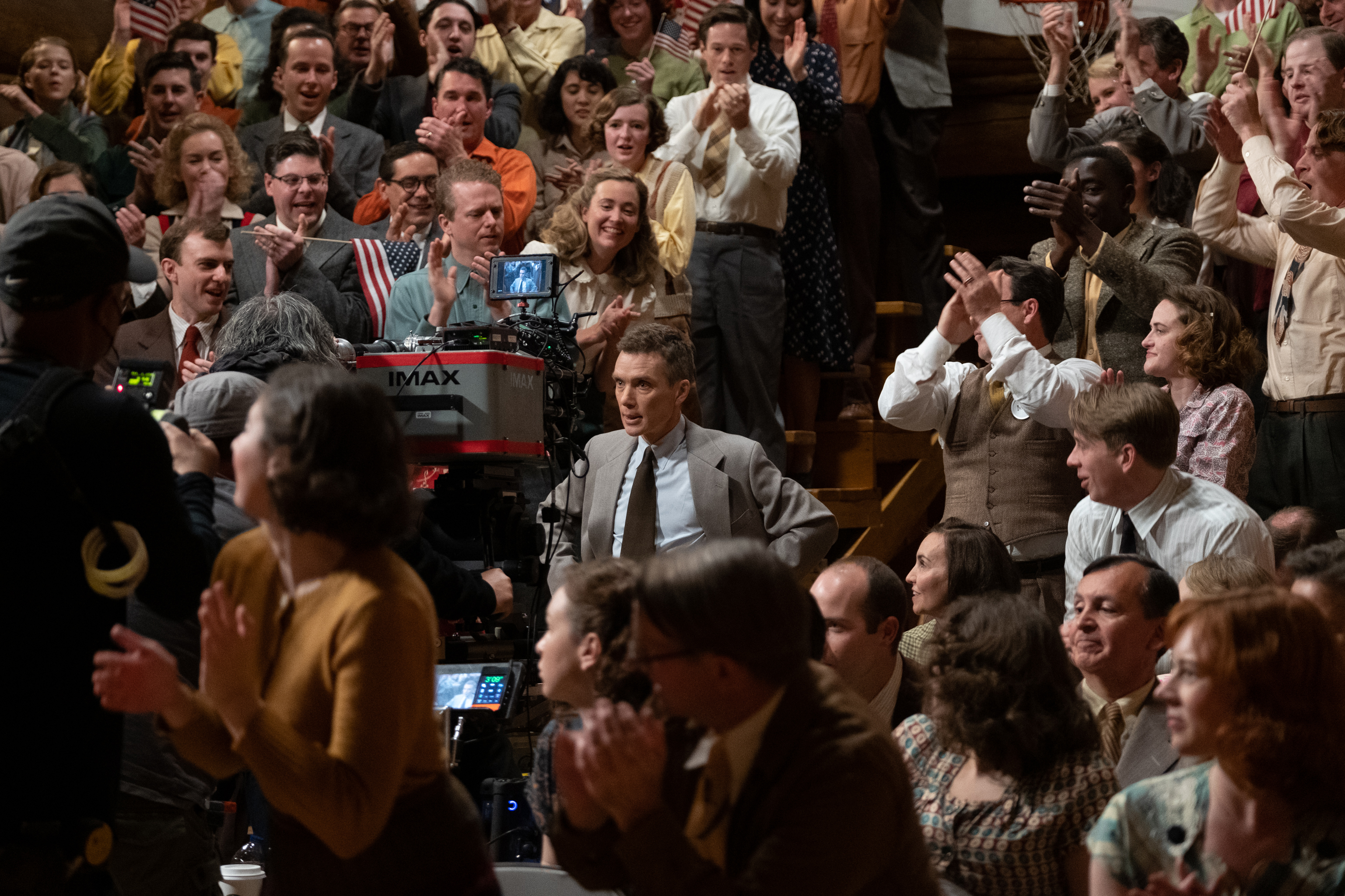 HD desktop wallpaper featuring a vibrant crowd scene with applause, possibly from the film Oppenheimer, suitable for use as a background.