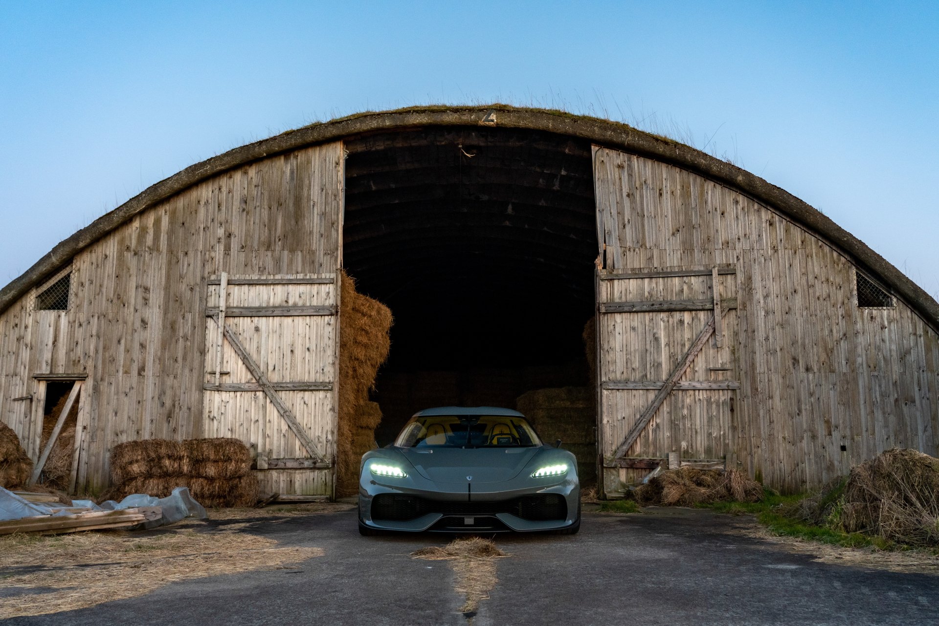Koenigsegg Gemera parked in front of an old barn, HD desktop wallpaper and background.