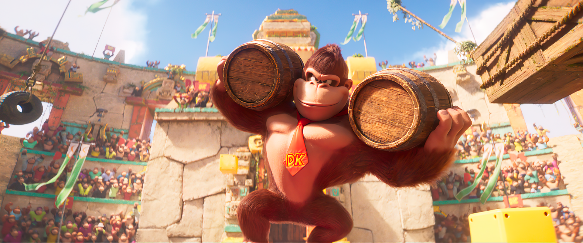 HD desktop wallpaper from the Super Mario Bros. movie (2023) featuring Donkey Kong holding barrels, with a festive crowd in background.