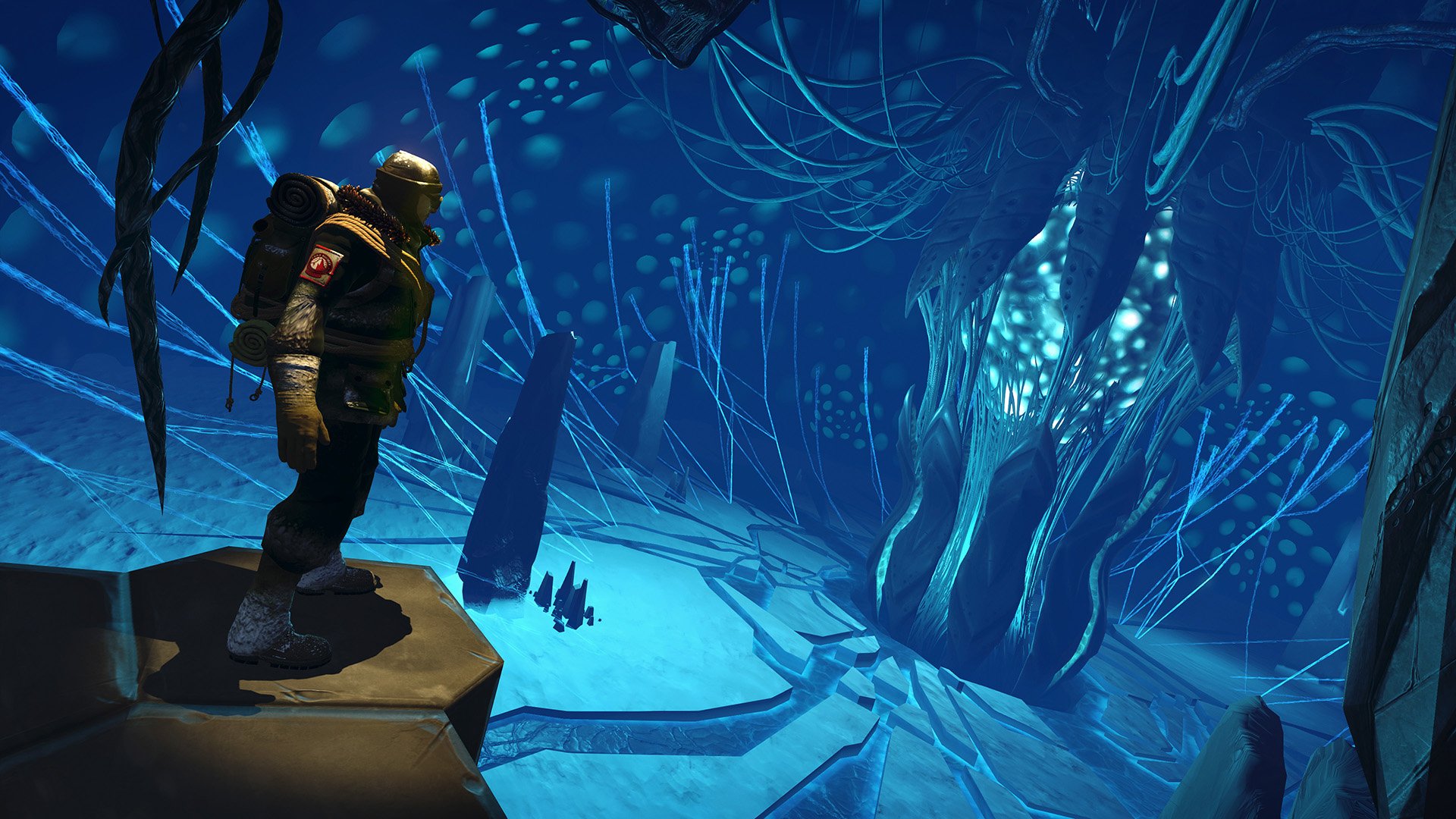 HD desktop wallpaper featuring a scene from the video game Edge of Nowhere, depicting an explorer in a mystical, icy cave with glowing blue tendrils.