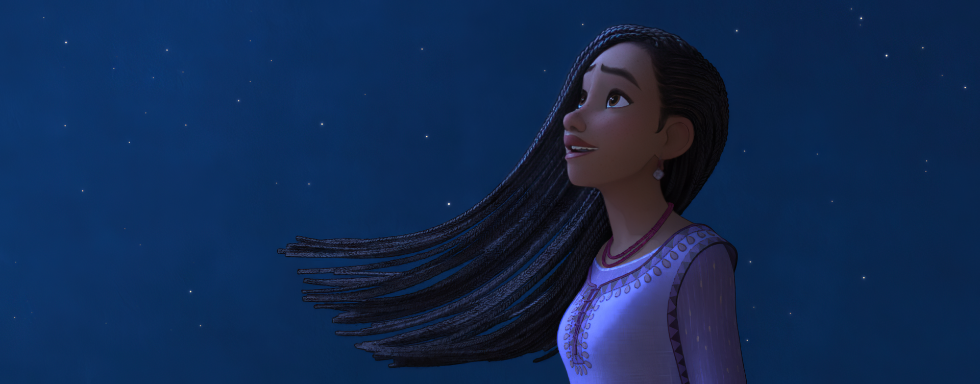 A character from the movie Wish (2023) gazes upward with a hopeful expression against a starry night sky, capturing a moment of wonder. This HD desktop wallpaper adds a magical touch to your background.