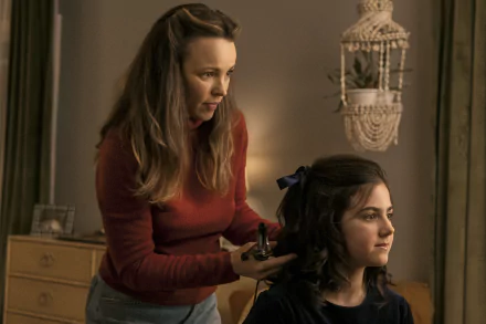 A scene from Are You There God? It's Me, Margaret, featuring a woman styling a girl's hair in a cozy room, serving as a vibrant HD desktop wallpaper and background.
