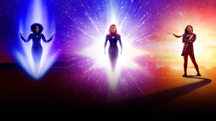 HD PC desktop wallpaper featuring characters from the movie The Marvels, with vibrant cosmic light effects and a dynamic superhero stance.