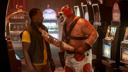 HD wallpaper of a scene from Twisted Metal featuring Anthony Mackie and Joe Seanoa in a tense standoff.