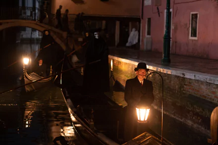 A haunting scene from A Haunting in Venice, featuring a figure in a hat holding a lantern on a darkened canal, with shadowy figures in the background, creating an eerie atmosphere.