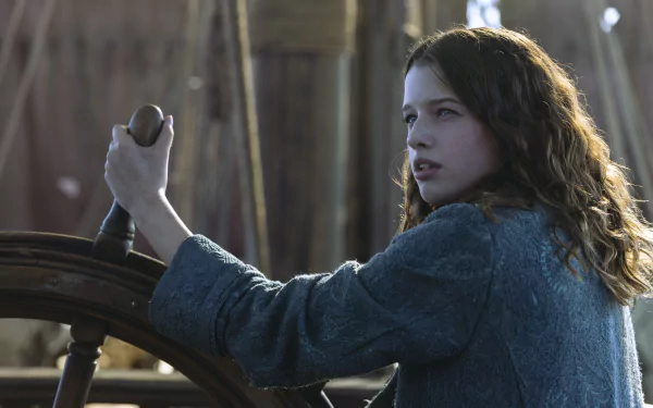 A scene from Peter Pan & Wendy, featuring a young girl at the helm of a ship, exuding determination and adventure. This HD wallpaper captures the magic of the movie beautifully.