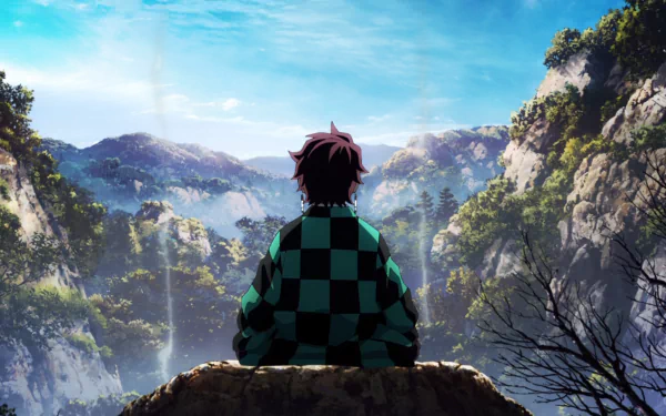 HD anime desktop wallpaper featuring Tanjiro Kamado from Demon Slayer: Kimetsu no Yaiba, seated and overlooking a scenic mountainous landscape with a bright blue sky.