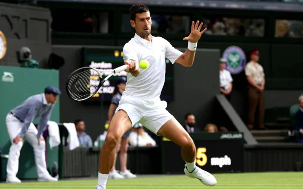 Novak Djokovic in action at Wimbledon 2023, skillfully returning a serve on the grass court, showcasing his athleticism and concentration in this stunning HD sports wallpaper.