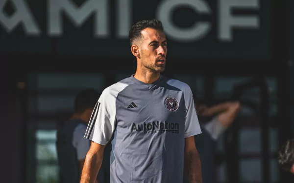 HD wallpaper featuring Sergio Busquets in Inter Miami CF training gear, captured in front of the team's logo.