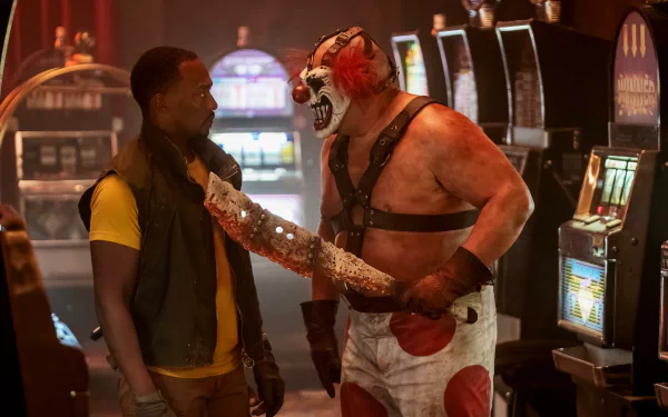 HD wallpaper of a scene from Twisted Metal featuring Anthony Mackie and Joe Seanoa in a tense standoff.