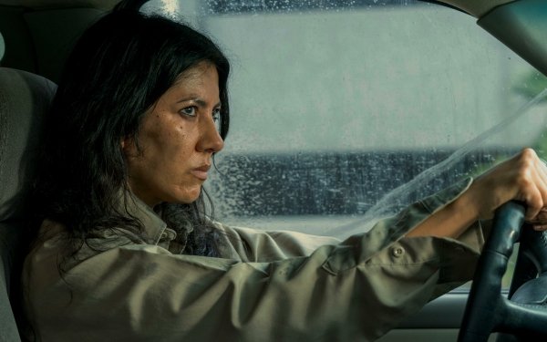 HD Wallpaper of a focused Stephanie Beatriz driving in a scene reminiscent of Twisted Metal, perfect for desktop backgrounds.