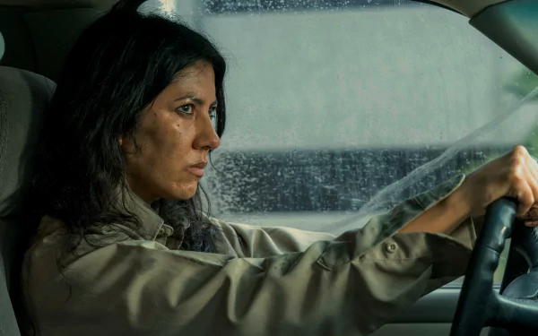 Stephanie Beatriz portrays a determined character in the TV show Twisted Metal, captured in a striking HD wallpaper as she focuses intently while driving through a rain-soaked window.