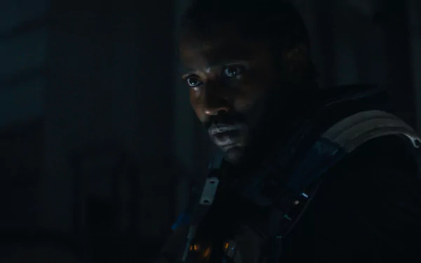 HD wallpaper of John David Washington in a scene from the 2023 movie The Creator, featuring a dimly lit, intense expression.