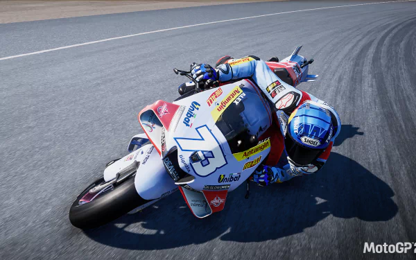 HD desktop wallpaper from the video game MotoGP 23 featuring a detailed action shot of a motorcyclist cornering sharply on a racetrack.