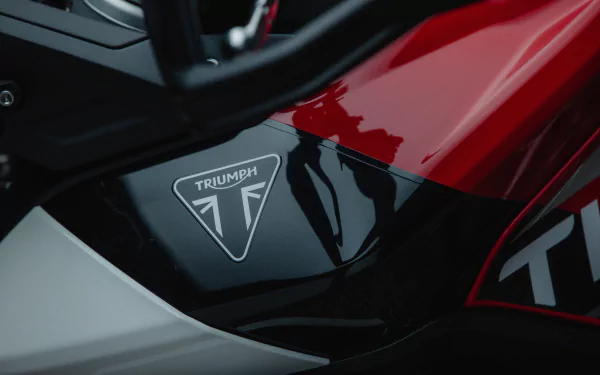 Close-up HD wallpaper of a Triumph Tiger 900 with visible logo, showcasing the sleek design of the Triumph Tiger 900 GT Aragón edition.