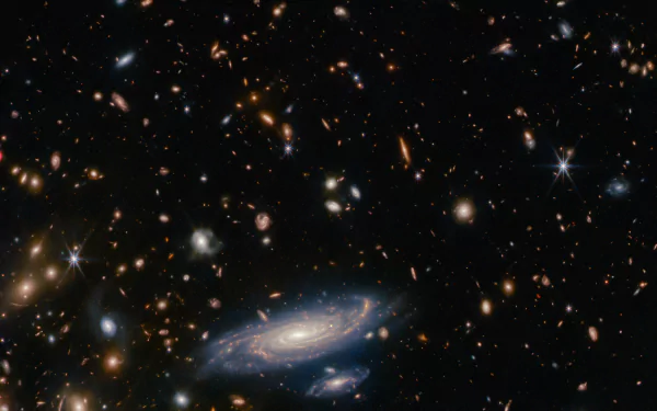 HD wallpaper featuring an awe-inspiring galaxy captured by the James Webb Space Telescope, set against a backdrop of distant stars and celestial bodies, evoking a sci-fi essence.