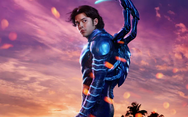 Blue Beetle movie 2K Quad HD PC desktop wallpaper: superhero in glowing armored beetle suit with mechanical scarab wings against a dramatic purple-orange sunset.