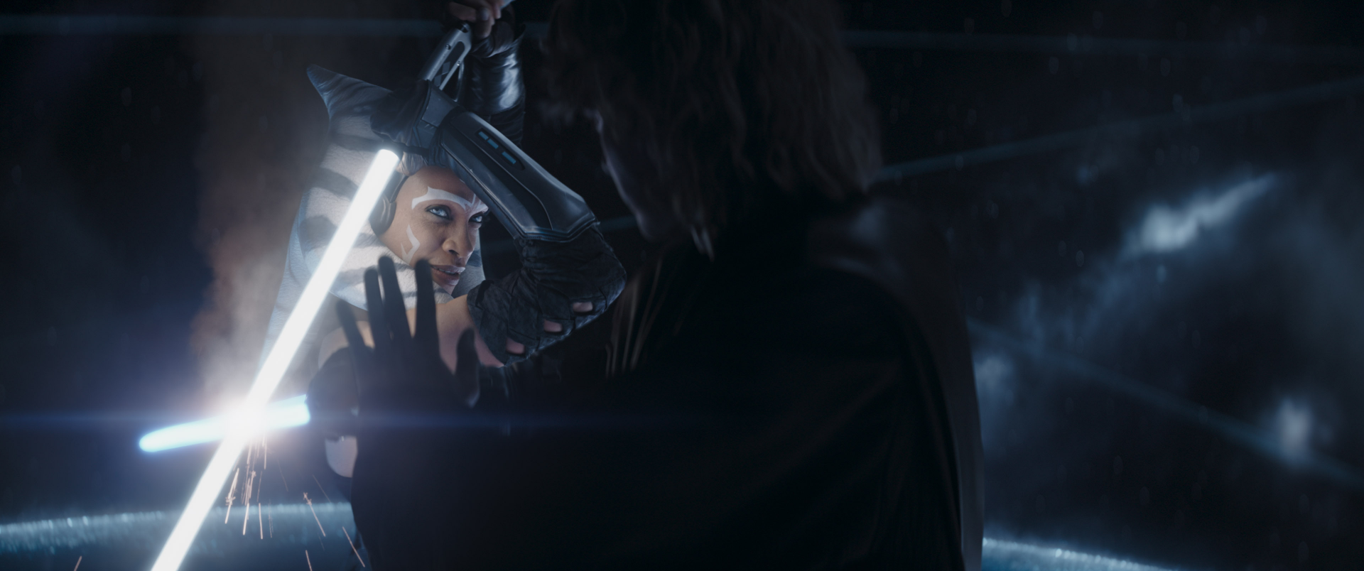 A dynamic scene from the TV show Ahsoka (2023), featuring a tense lightsaber confrontation amid a dramatic backdrop, capturing the intensity of the moment in HD quality.