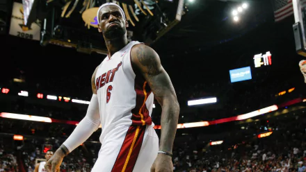 HD desktop wallpaper featuring LeBron James in a Miami Heat jersey during a basketball game, showcasing an intense moment on the court.
