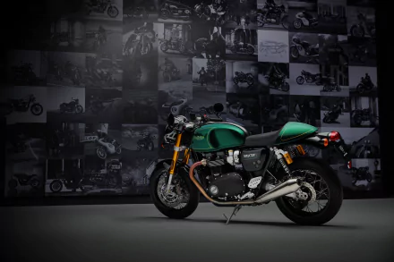 The Triumph Thruxton Final Edition, showcased in a striking green hue, stands prominently against a backdrop of motorcycle imagery in this HD desktop wallpaper.