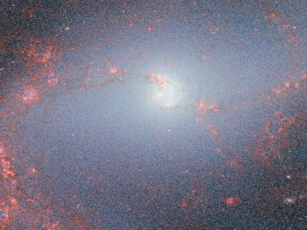 HD desktop wallpaper of a galaxy captured by the James Webb Space Telescope, featuring luminescent galactic core and surrounding star clusters, embodying a sci-fi aesthetic.