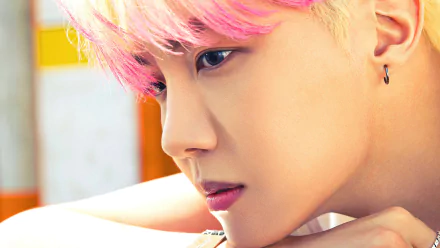 HD desktop wallpaper featuring a close-up of J-Hope from BTS with pink hair, giving a serious gaze.