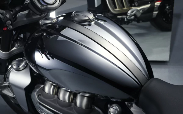 Close-up of the Triumph Rocket III R, featuring sleek chrome detailing on the fuel tank. An eye-catching HD desktop wallpaper showcasing the Triumph Chrome Edition vehicle.