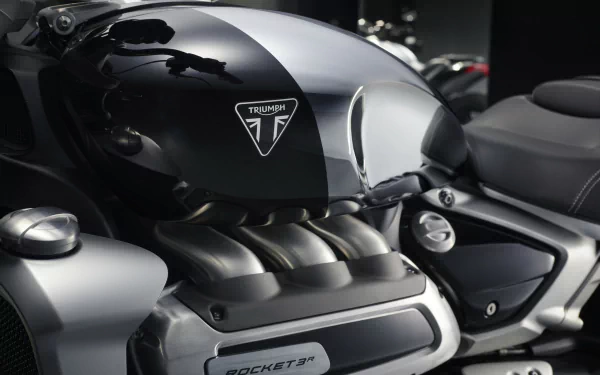 Close-up of the Triumph Rocket III R Chrome Edition, showcasing its sleek design and powerful engine. A striking HD wallpaper featuring this iconic vehicle.