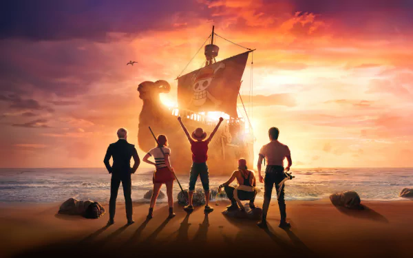 4K Ultra HD desktop wallpaper featuring the live-action One Piece TV show cast standing on a beach with the Thousand Sunny ship at sunset.
