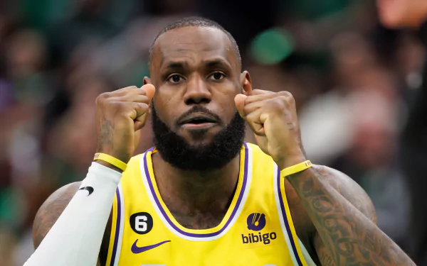 HD desktop wallpaper featuring a basketball player in a yellow and purple jersey focusing during a game for an inspirational and dynamic background.