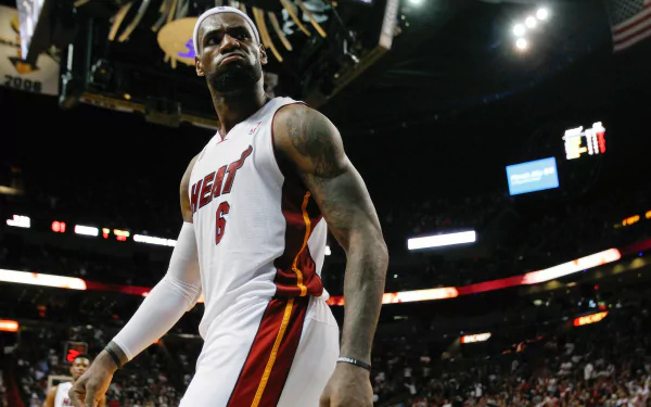 HD desktop wallpaper featuring LeBron James in a Miami Heat jersey during a basketball game, showcasing an intense moment on the court.