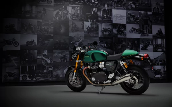 The Triumph Thruxton Final Edition, showcased in a striking green hue, stands prominently against a backdrop of motorcycle imagery in this HD desktop wallpaper.