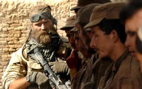 A bearded soldier in military gear stands confidently with a rifle, surrounded by fellow servicemen, showcasing a moment from the United States Army. HD desktop wallpaper.