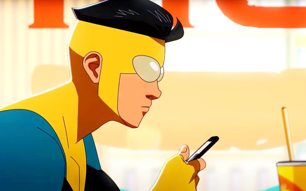 HD desktop wallpaper featuring Invincible (Mark Grayson) from Image Comics, focused on his phone with a vibrant background.