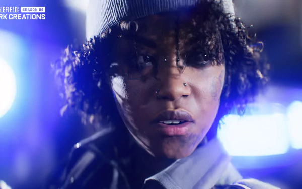 HD desktop wallpaper featuring a close-up of a female character from Battlefield 2042, with a focused expression and atmospheric blue lighting.