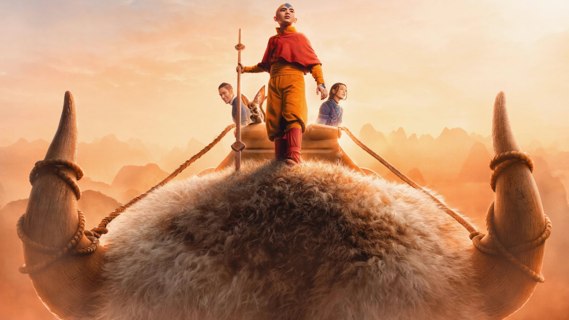 HD PC desktop wallpaper featuring characters from the TV show Avatar: The Last Airbender standing on Appa against a warm, glowing sky backdrop.