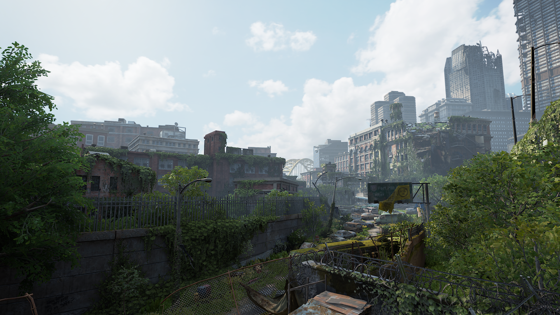 HD PC desktop wallpaper featuring a post-apocalyptic cityscape from the video game The Last of Us Part I, showcasing overgrown ruins and abandoned buildings.