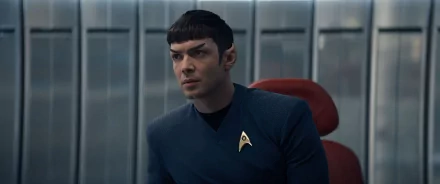 HD wallpaper featuring a character from Star Trek: Strange New Worlds in a blue Starfleet uniform, embodying the iconic role of Spock.