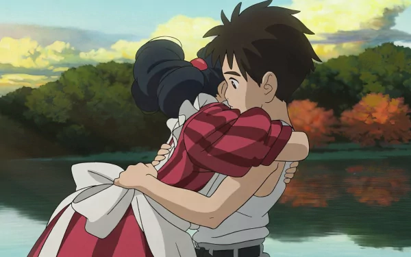 HD desktop wallpaper featuring a tender embrace between two animated characters from The Boy and the Heron by Studio Ghibli, set against an autumn lakeside backdrop.