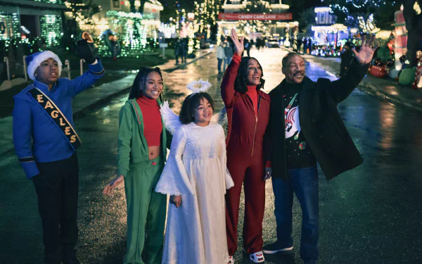 A festive scene from the movie Candy Cane Lane, featuring a group of five characters joyfully waving amidst a brightly decorated street illuminated with holiday lights.