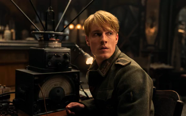 HD desktop wallpaper featuring a scene from the TV show 'All the Light We Cannot See' with a character in a vintage room with radio equipment.