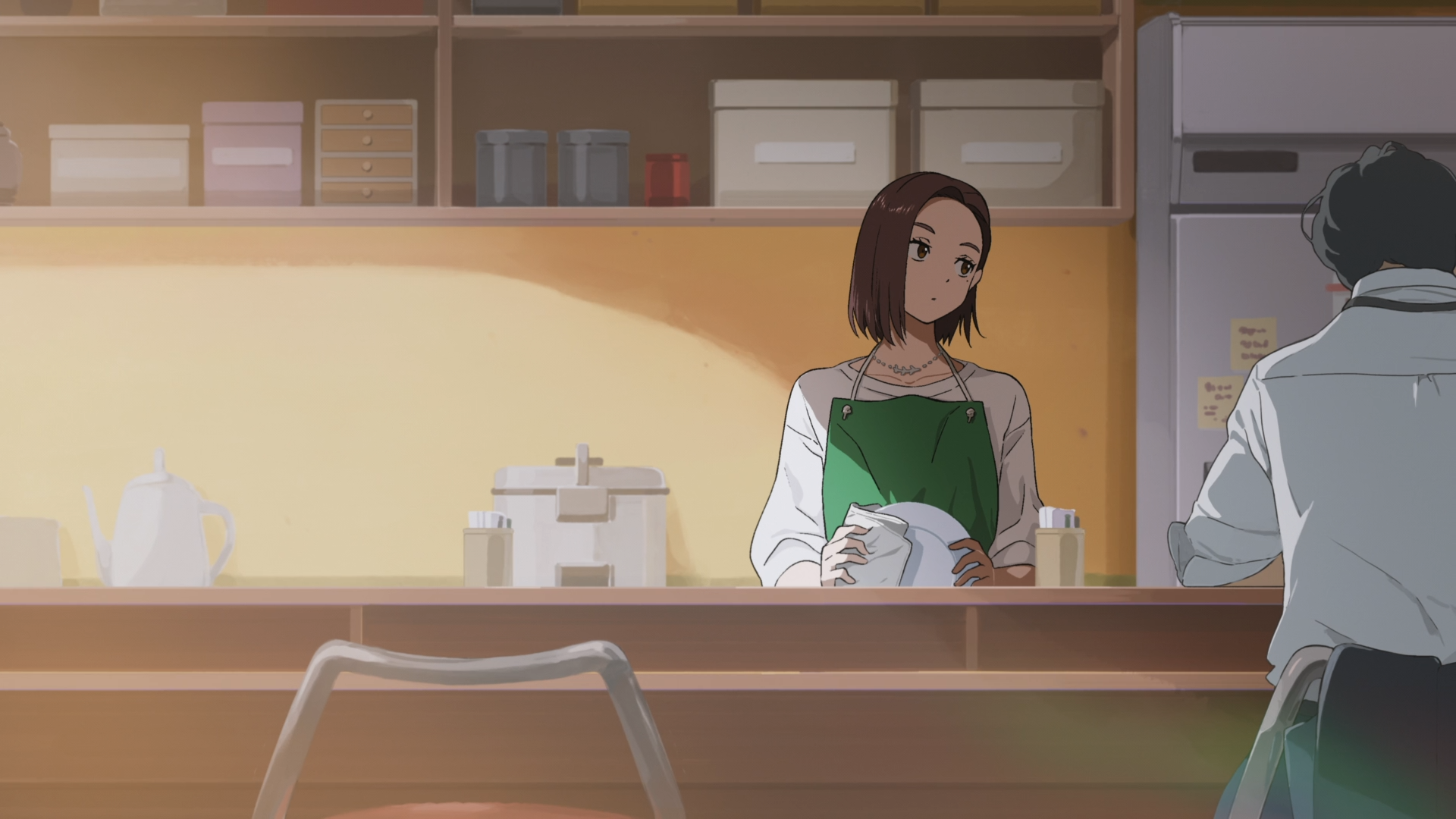 Anime HD PC desktop wallpaper of Kotoha Tachibana from Wind Breaker standing behind a café counter in a softly lit, warm interior setting.