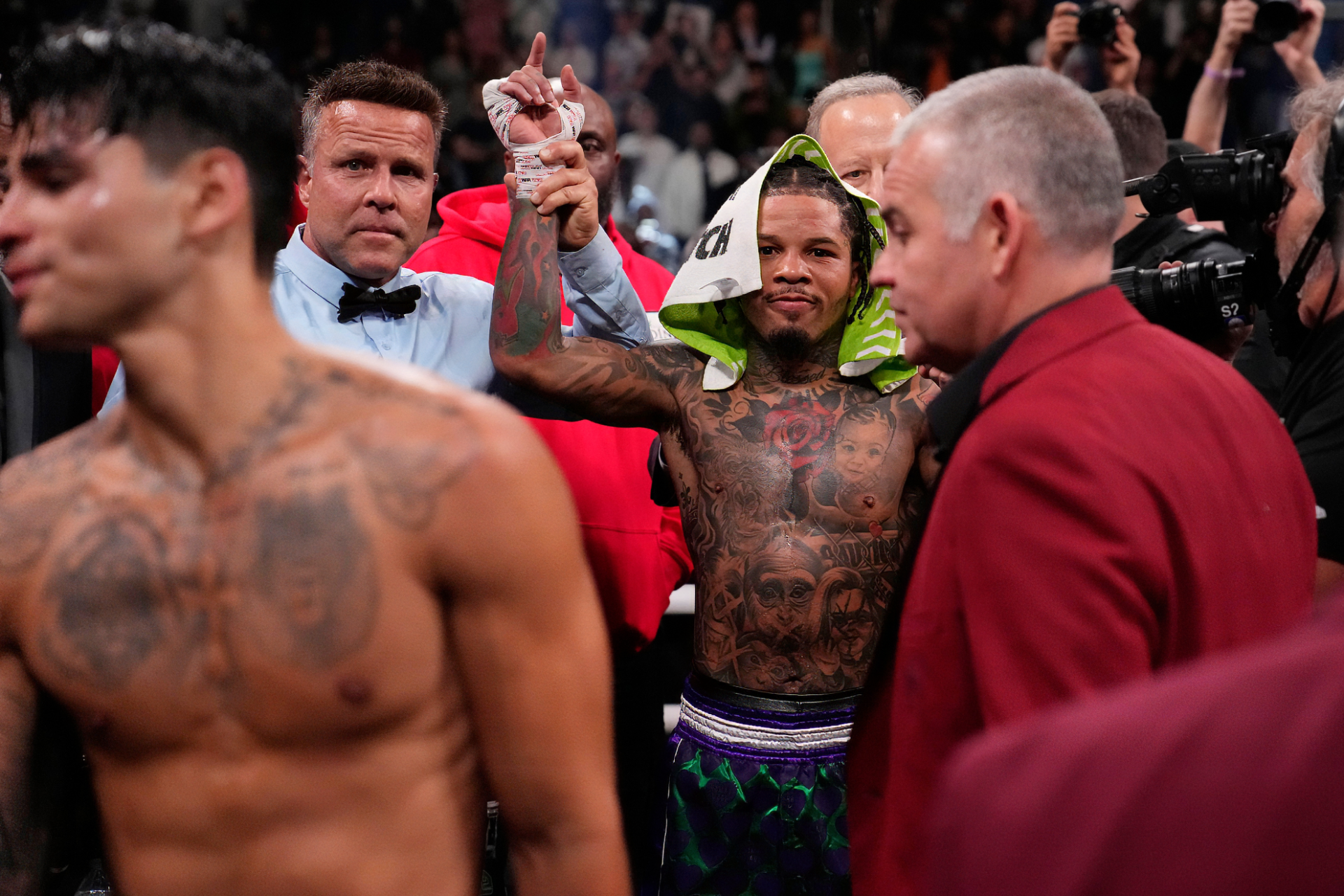 HD desktop wallpaper featuring a boxing scene with a victorious boxer wearing a hooded robe, surrounded by officials and another boxer in the foreground.