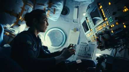 HD wallpaper featuring an intense scene from the 2024 TV show Constellation with a character portrayed by Noomi Rapace inside a spacecraft.